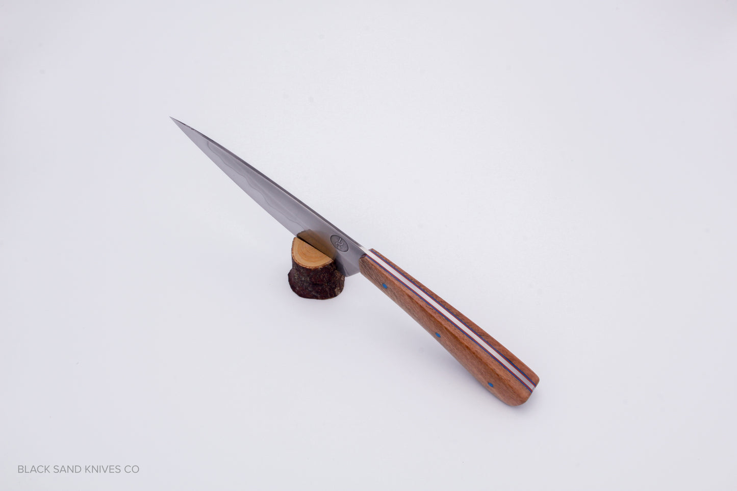 5.5" (140mm) Petty with Hamon in W2 High Carbon Steel with Macadamia Wood Handles - Blue and red liners