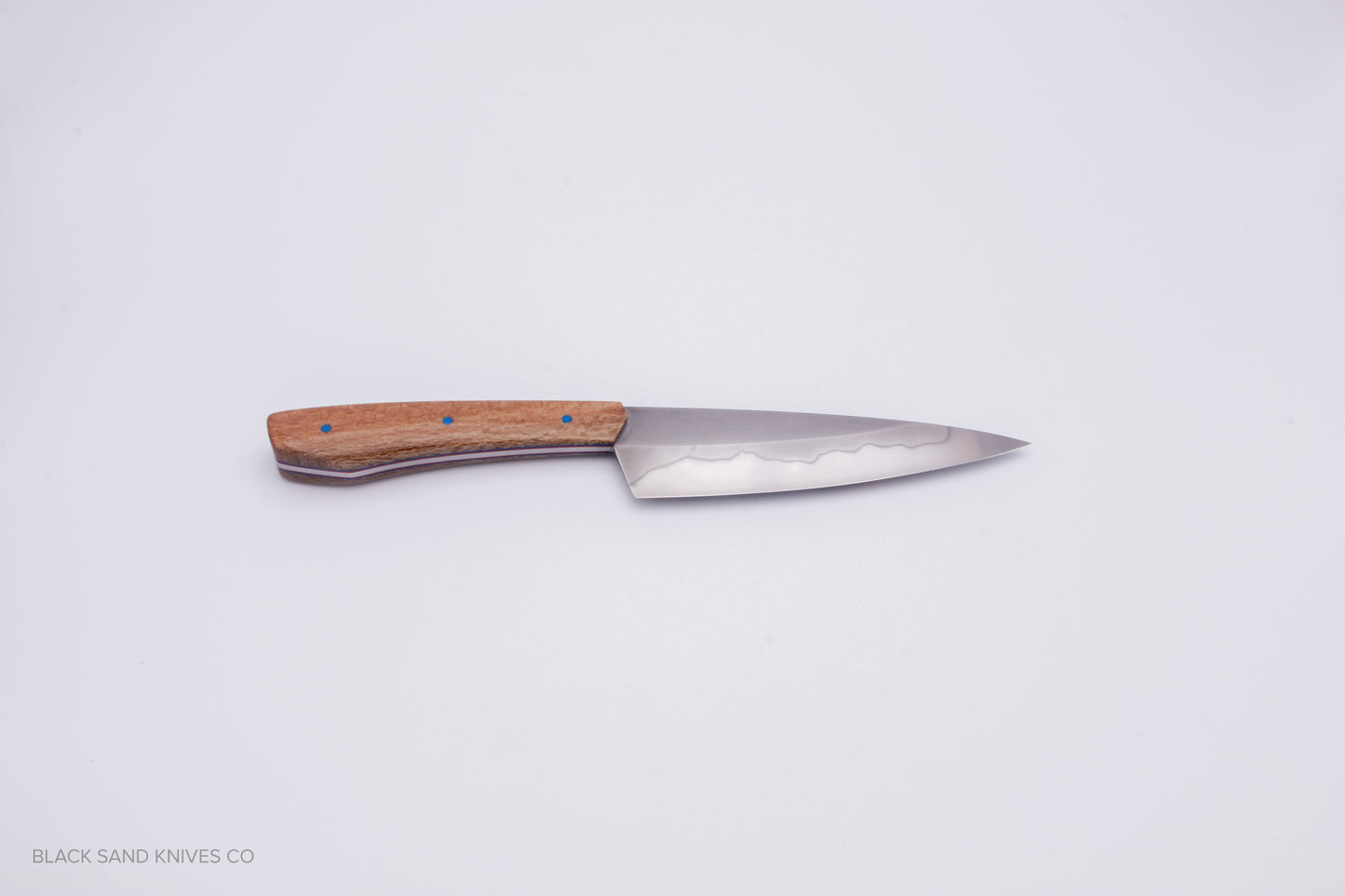 5.5" (140mm) Petty with Hamon in W2 High Carbon Steel with Macadamia Wood Handles - Blue and red liners