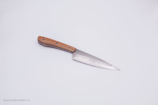 5.5" (140mm) Petty with Hamon in W2 High Carbon Steel with Macadamia Wood Handles - Blue and red liners
