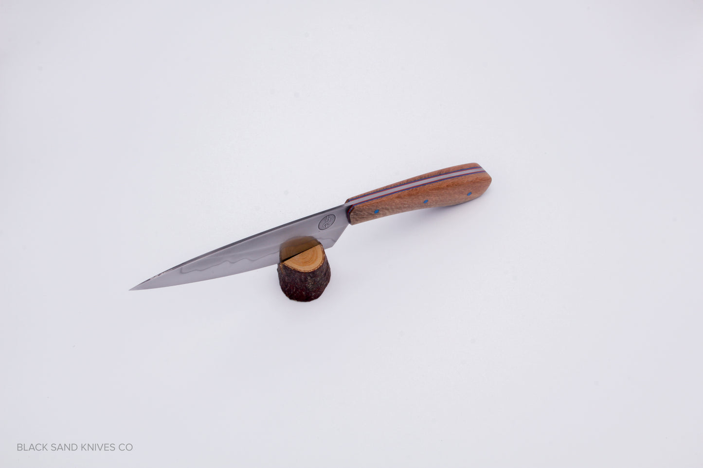 5.5" (140mm) Petty with Hamon in W2 High Carbon Steel with Macadamia Wood Handles - Blue and red liners